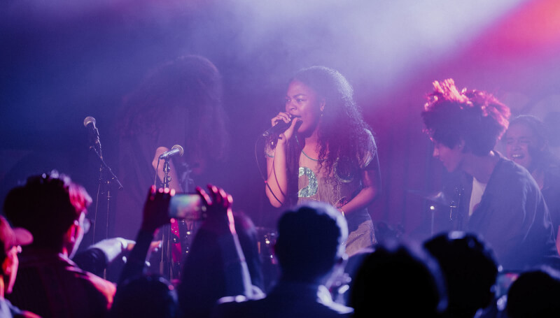 School of Rock student singing on stage