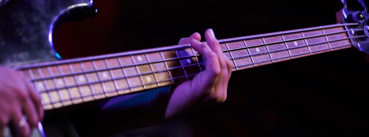 Kid learns to play bass at School of Rock