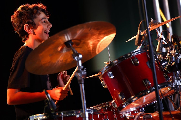 Young boy playing drums