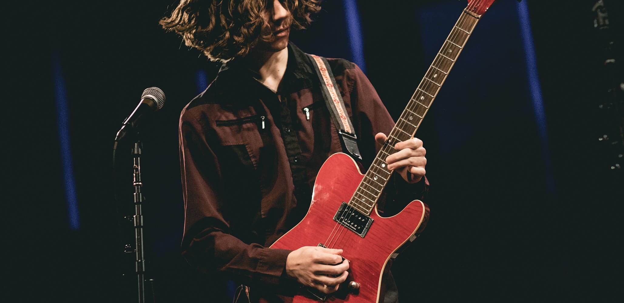 A School of Rock student playing an electric guitar