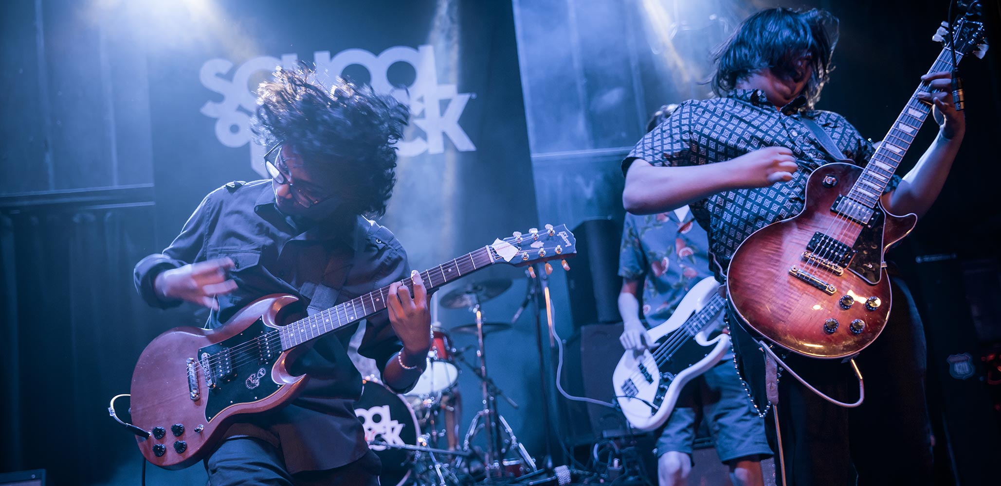 Photo of two students showing energy on stage