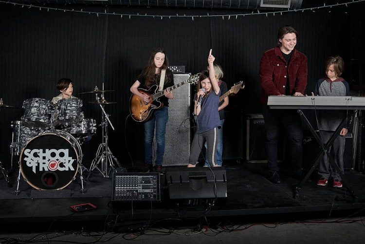 Student taking piano lessons for beginners onstage