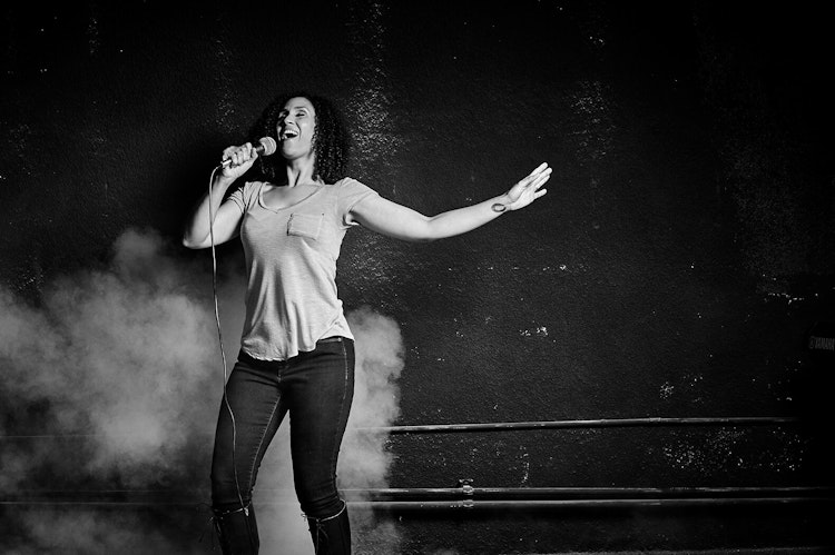 woman belting out a song on a microphone