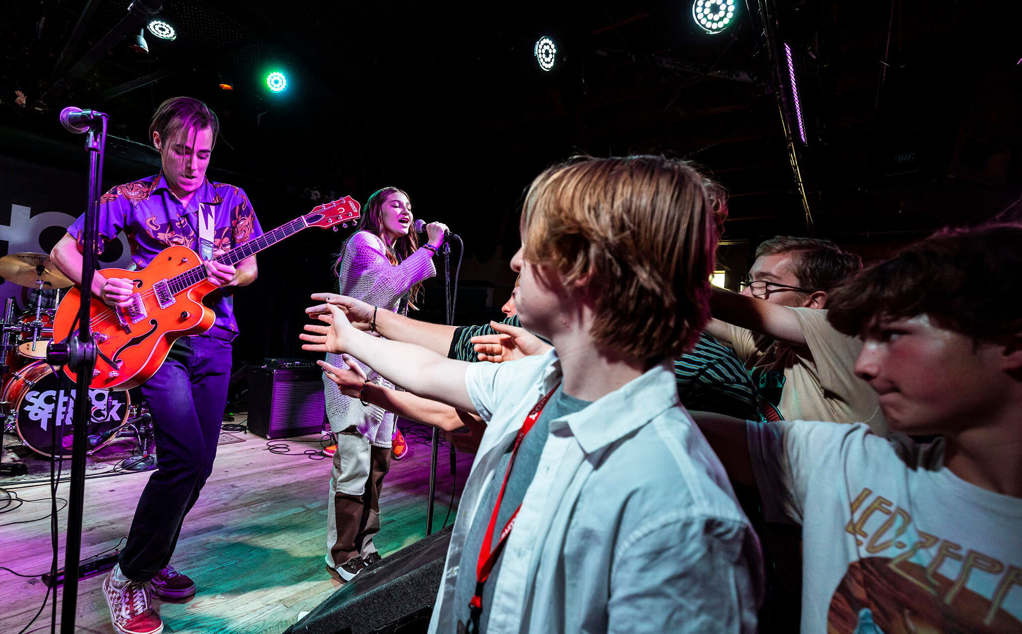 School of Rock student playing the guitar on stage