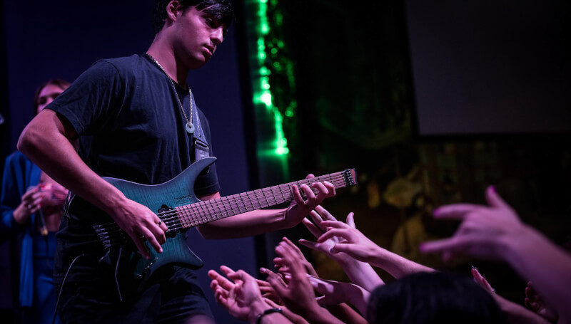 School of Rock guitar student performing on stage