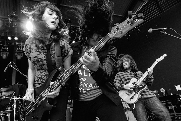 kids playing a bass guitar at a School Of Rock concert