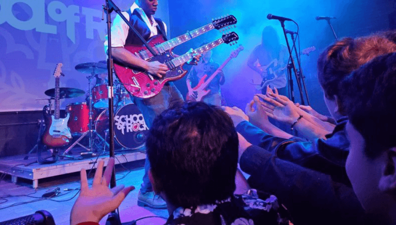 School of Rock student playing a two-necked guitar